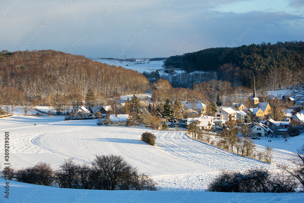A village in bavaria under a heavy fall of snow on a beautiful winter's day