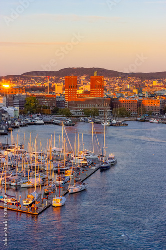 Sunset aeriel view at harbour of Oslo with boats and the famous city hall, Norway