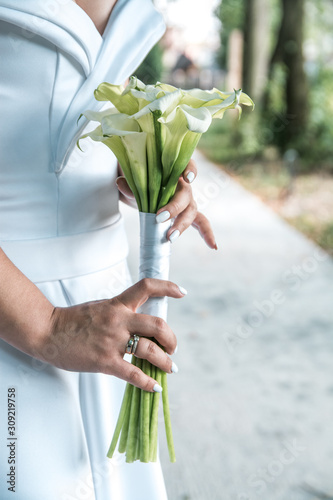 wedding bouquet of flowers in the hands of the bride