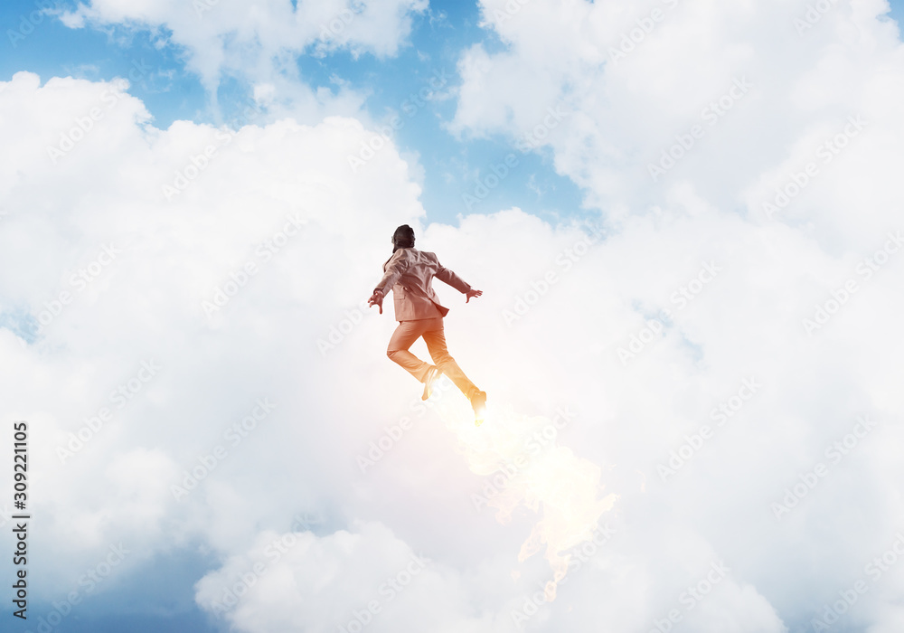 Businessman in suit and aviator hat flying in sky Businessman in suit and aviator hat flying in sky