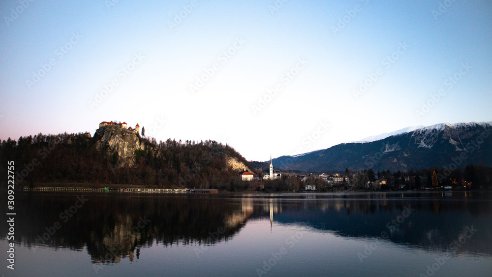 Sunrise view of lake Bled in winter with the castle and town