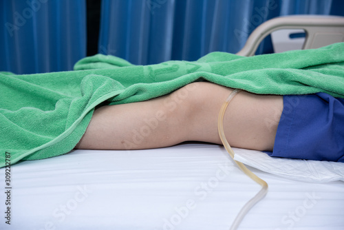 Drainage a urine pass to a urine bag hanging under patient bed in hospital