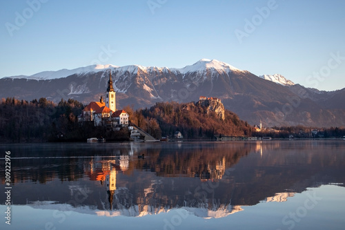 Sunrise view of lake Bled in sunny winter with the island, castle and church