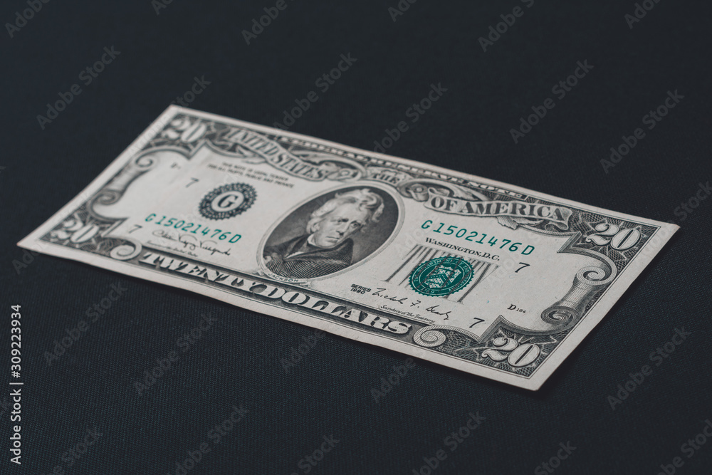 One twenty dollar bill isolated on a black background. One twenty dollar bill isolated on a black background.