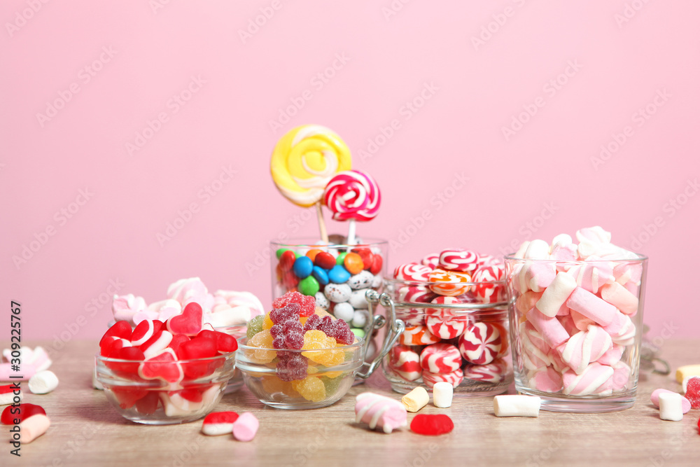 various candy and sweets on the table on a colored background. 