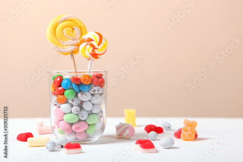 various candy and sweets on the table on a colored background. 