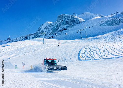 People with Ski and snowboard in Hintertux Glacier ratrack working