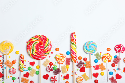 Candies and sweets on a light background, top view with place for text.