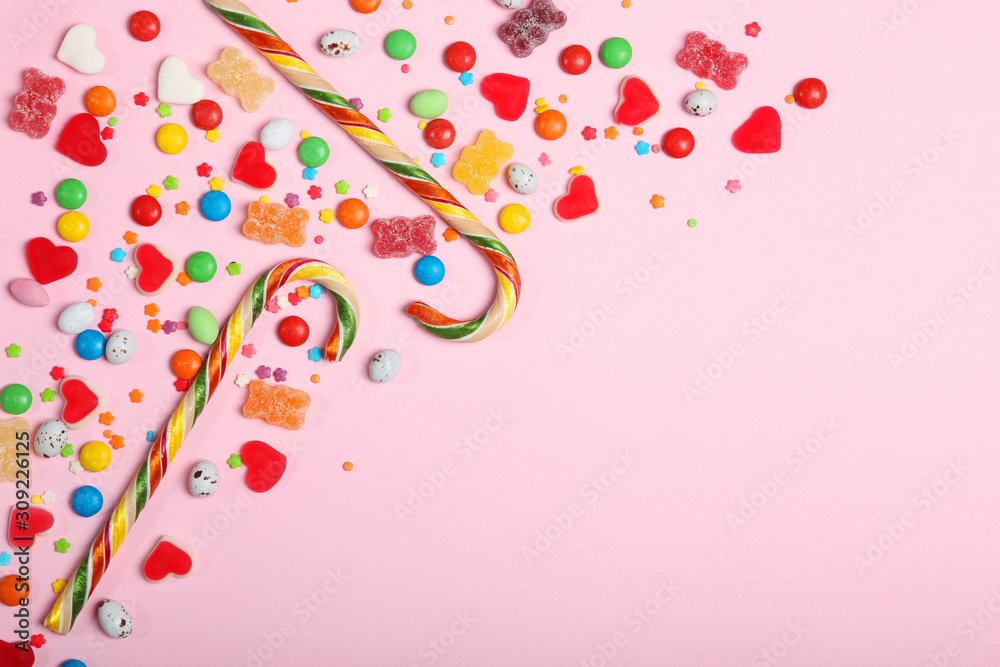 Candies and sweets on a colored background top view with place for text.
