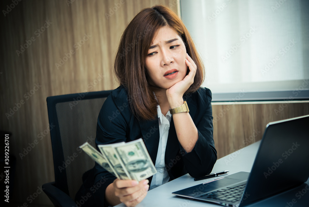 Asian woman working in office,young business woman stressed from work overload with a lot file on the desk,Thailand people Think so much about the salary that is not enough to spend. Asian woman working in office,young business woman stressed from work overload with a lot file on the desk,Thailand people Think so much about the salary that is not enough to spend.