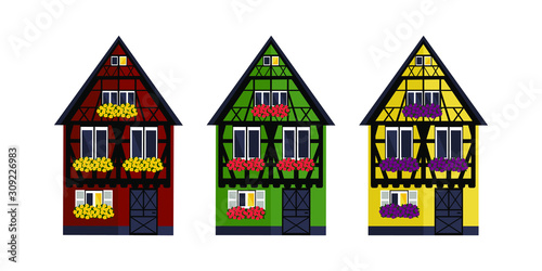 Three houses of different colors in Alsaces style. Green, red and yellow houses in Alsaces style.