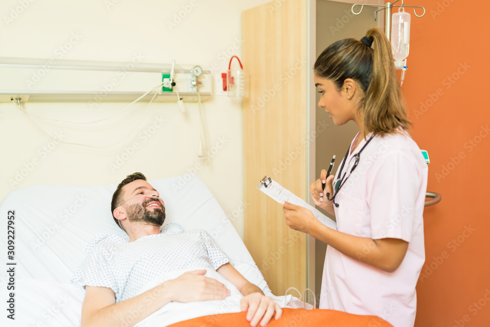 Healthcare Worker Explaining Records To Patient At Hospital Healthcare Worker Explaining Records To Patient At Hospital