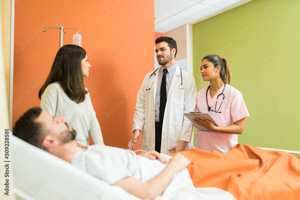 Woman And Patient Talking To Healthcare Workers Woman And Patient Talking To Healthcare Workers