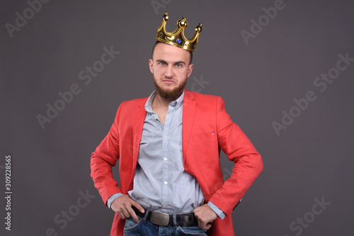 Cuadro en lienzo Portrait of self-confident male in red jacket with crown on his head