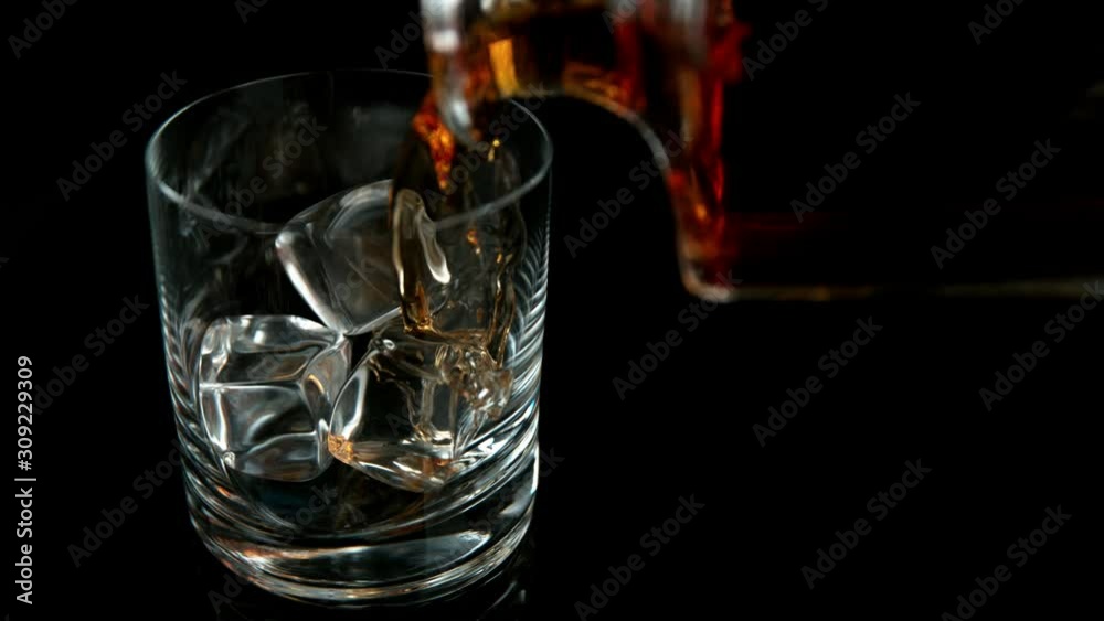 Super slow motion of pouring whiskey or rum with slide motion. Filmed on high speed cinema camera, 1000 fps. Super slow motion of pouring whiskey or rum with slide motion. Filmed on high speed cinema camera, 1000 fps.