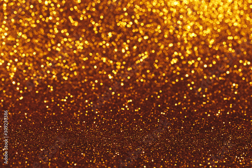 Christmas abstract texture, golden sparkles bokeh shining background.