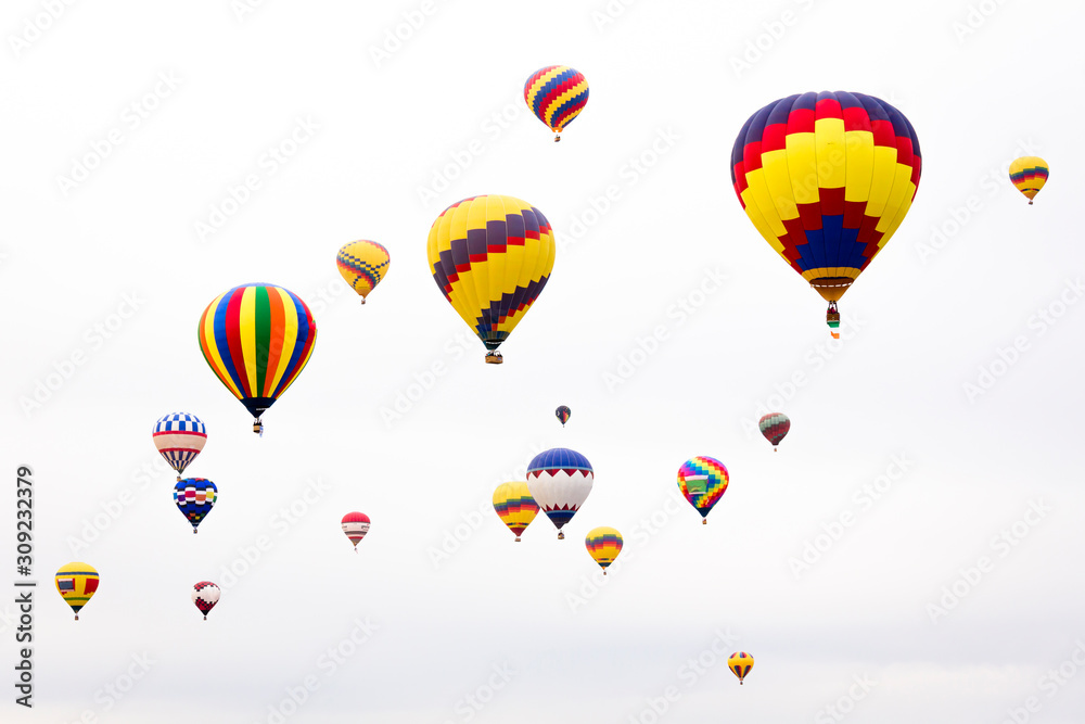 USA, New Mexico, Albuquerque. International Balloon Festival. Hot air balloons rise into a white sky after launch. USA, New Mexico, Albuquerque. International Balloon Festival. Hot air balloons rise into a white sky after launch.