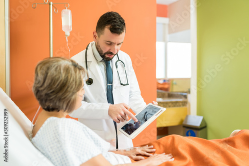 Healthcare Worker Showing Xray To Patient At Hospital