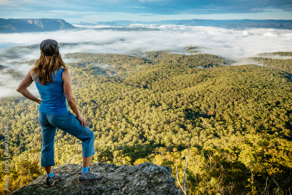 A woman looks out over the Megalong valley from Hargreaves Lookout, Blue Mountains National Park. A woman looks out over the Megalong valley from Hargreaves Lookout, Blue Mountains National Park.