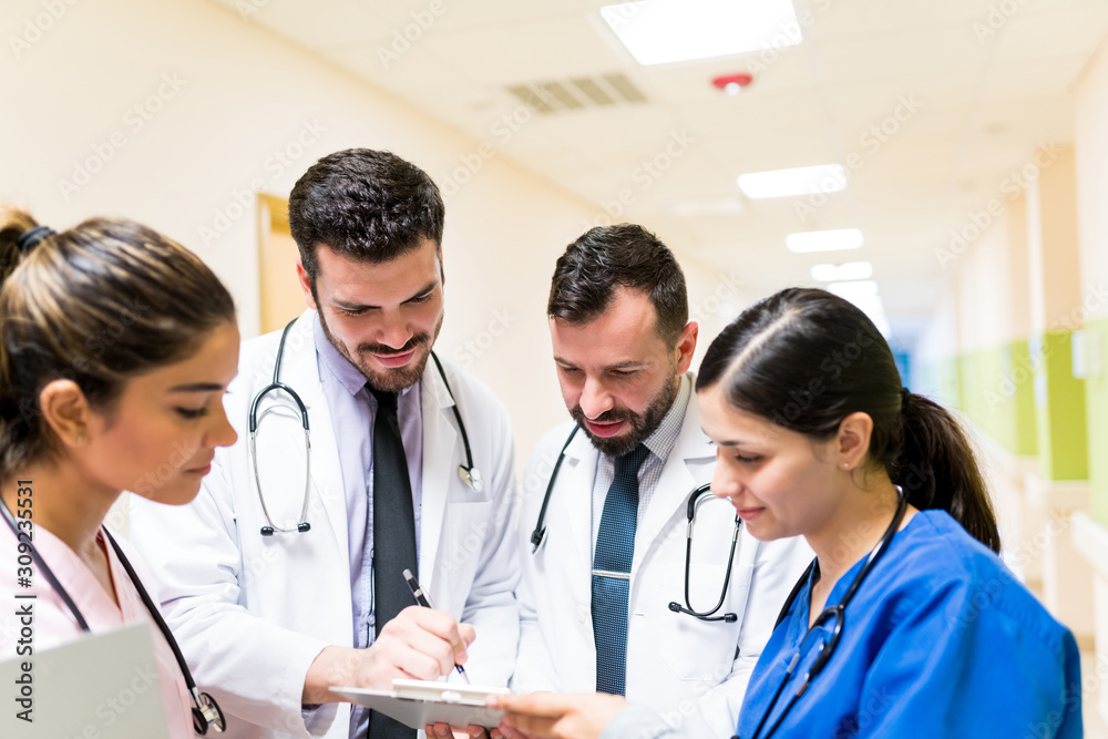 Doctor And Nurses Discussing Over Reports In Hospital Doctor And Nurses Discussing Over Reports In Hospital