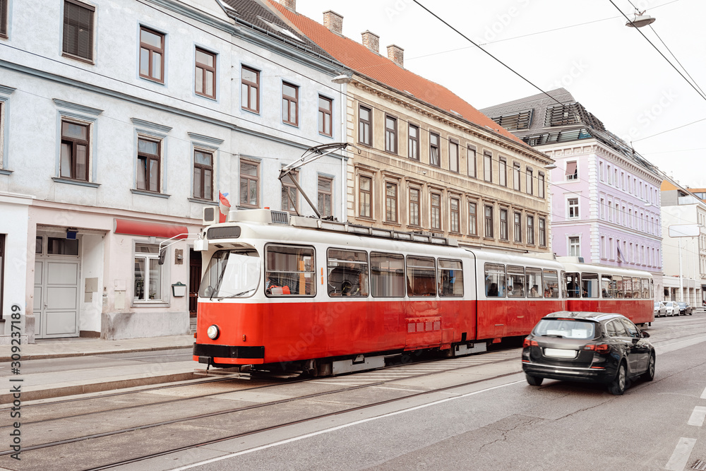 Typical red tram on road in Mariahilfer Strasse in Vienna