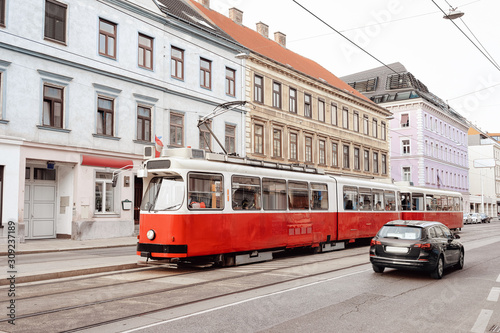 Typical red tram on road in Mariahilfer Strasse in Vienna