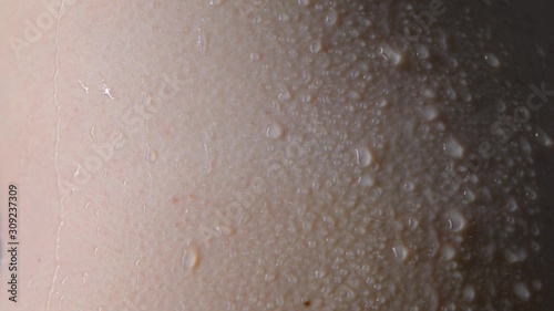 Drops, droplets run down the skin, trickles on wet skin