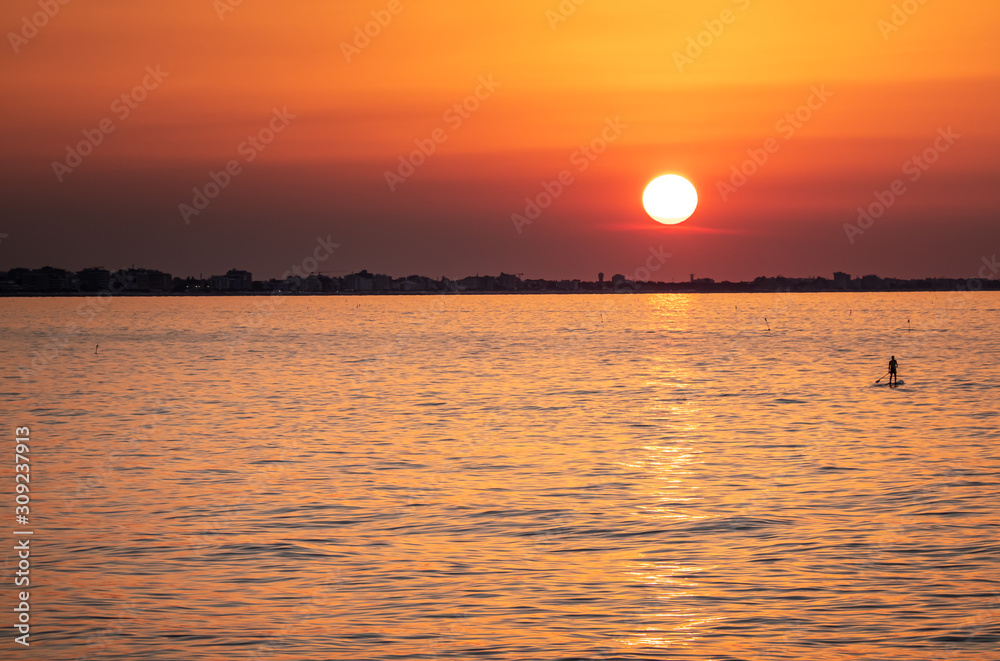 Scenic Red Sunset on the Sea with Silhouette of Man