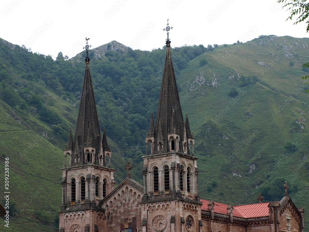 Basilica of Covadonga in Asturias with the green mountains in the background