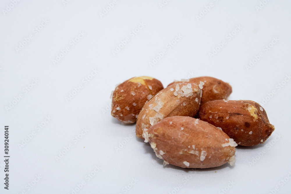  salted peanuts on a white background