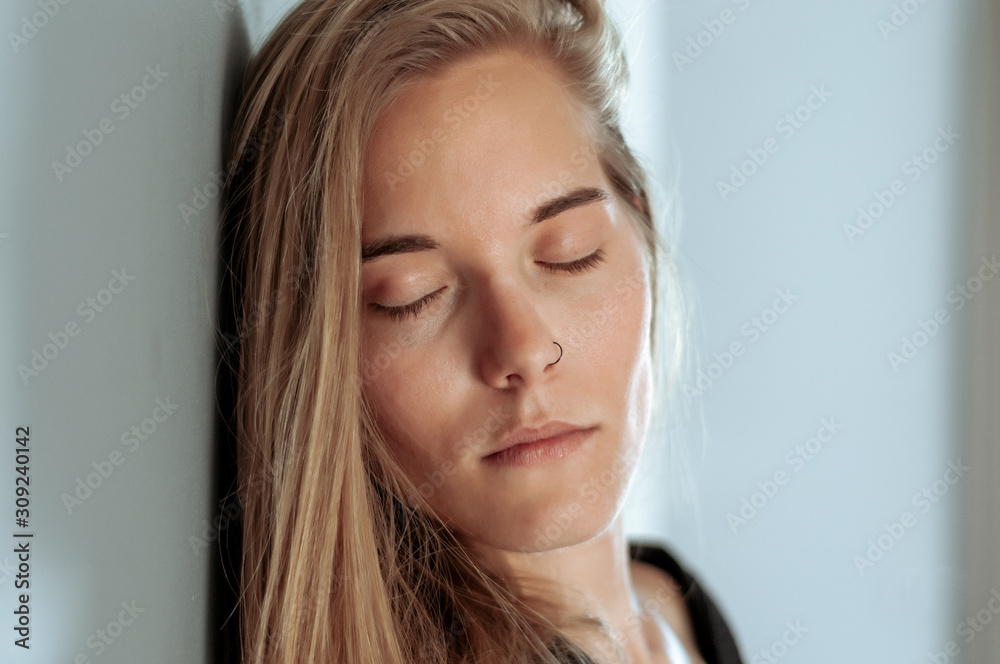 Young blonde woman, with black shirt, photographed at home Young blonde woman, with black shirt, photographed at home