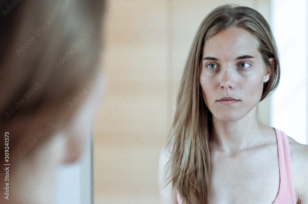 Young blond girl photographed in front of the mirror Young blond girl photographed in front of the mirror