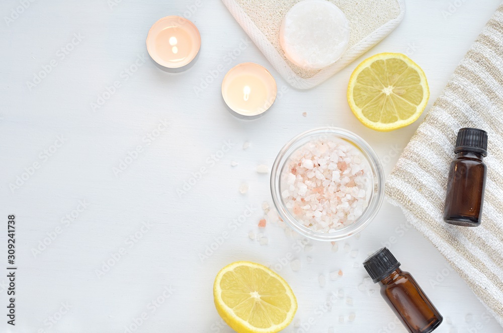 Ingredients for body scrub, lemon, pink sea salt, essential oils. Spa composition, top view, copy space. Ingredients for body scrub, lemon, pink sea salt, essential oils. Spa composition, top view, copy space.