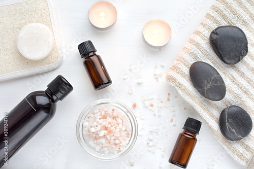 Spa composition, beauty and massage products, essential oils, massage stones, sea salt, candles.