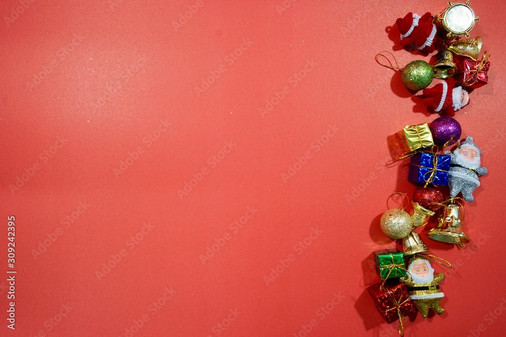 Christmas red background with herringbone and decor. Gold and red jewelry. Top view