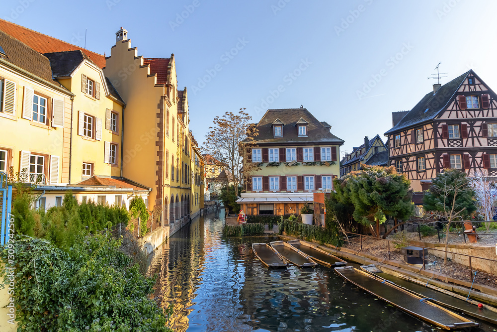 Traditional Alsatian half-timbered houses and river Lauch in Petite Venise or little Venice, old town of Colmar, decorated and illuminated at christmas time, Alsace, France