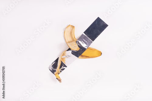 eaten banana on  duct-taped on white background
