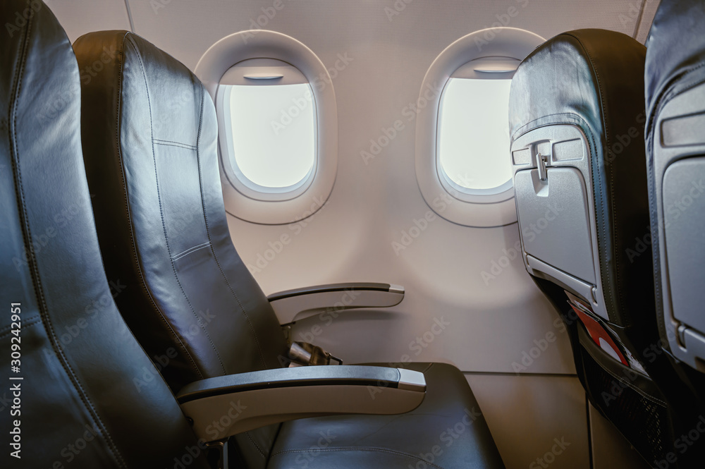 Airplane seats in the economy cabin class Airplane seats in the economy cabin class