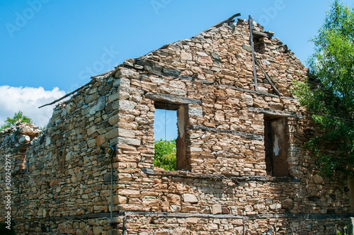 Old destroyed abandoned rural stone house closeup