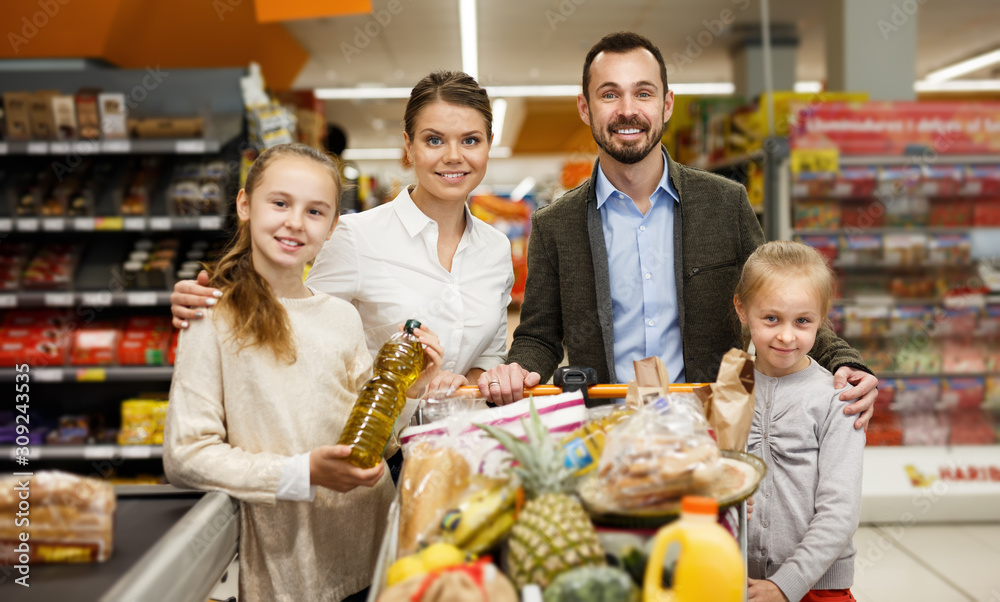 Portrait of happy family children who are standing in  shop