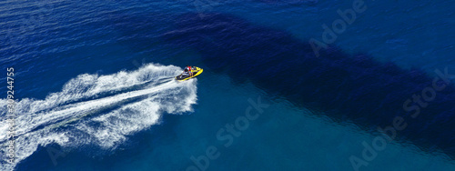 Aerial photo of jet ski with couple cruising in high speed in Caribbean tropical crystal clear waters © aerial-drone