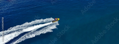 Aerial photo of jet ski with couple cruising in high speed in Caribbean tropical crystal clear waters © aerial-drone