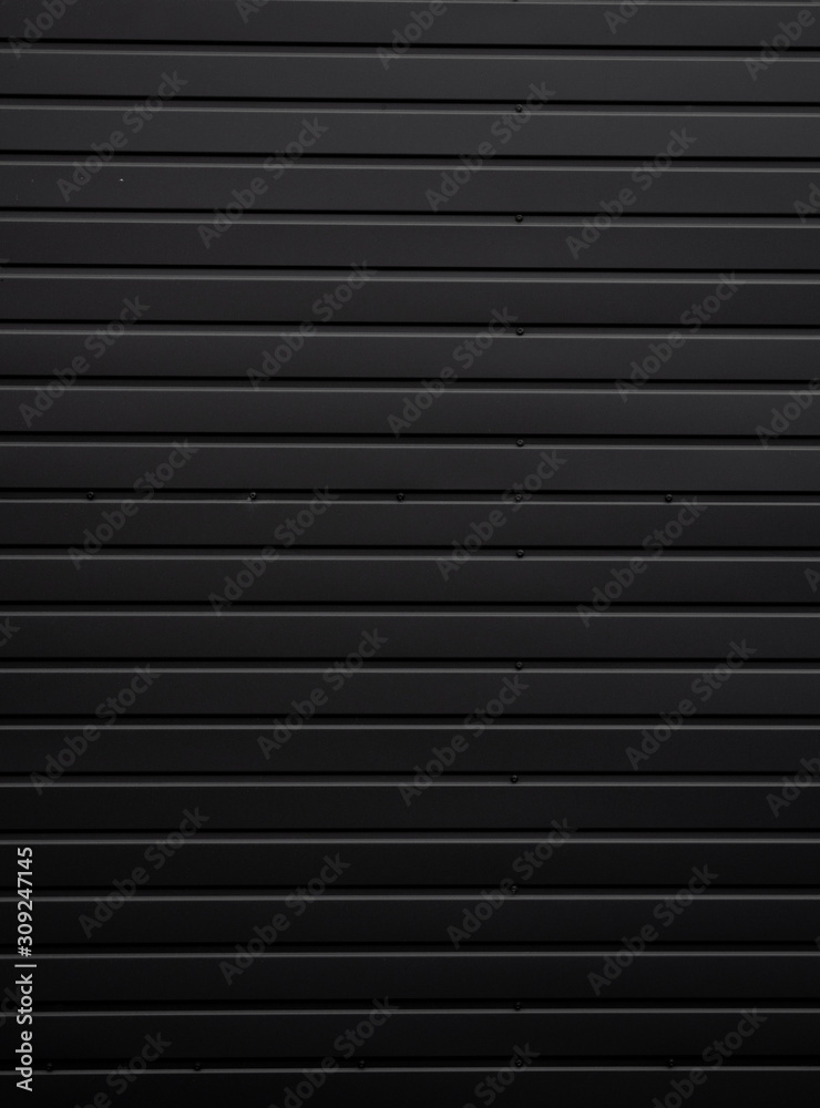 Black Corrugated metal sheet texture surface of the wall. Galvanize steel background. Black Corrugated metal sheet texture surface of the wall. Galvanize steel background.