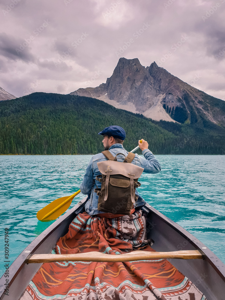 young men visit Emerald Lake, Canoeing on Emerald Lake in summer at the Yoho National Park