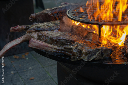 Tomahawk rib steak on hot grill