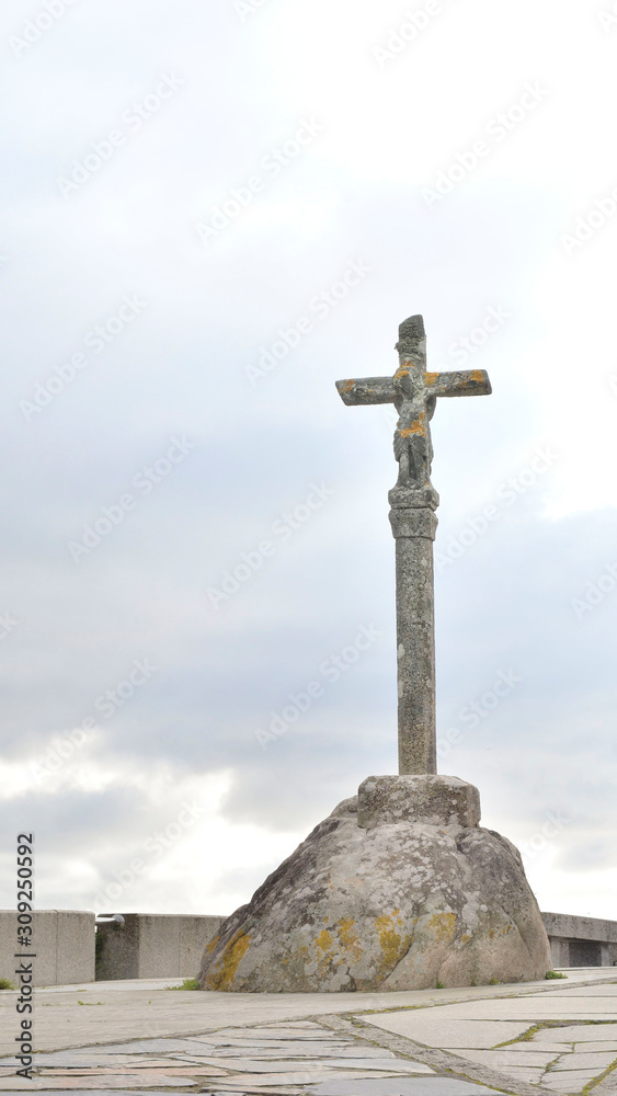 Stone cross in Finisterre on the Camino de Santiago, Galicia, Spain. These symbols were built since the XVII century to sanctify the roads and pilgrims who walk to Santiago.