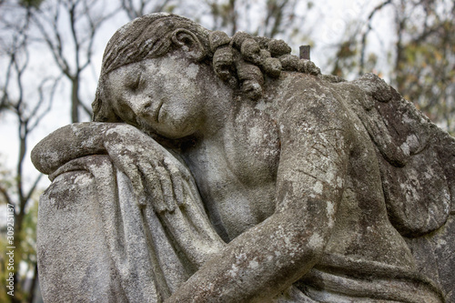 An image of a woman crying on the grave