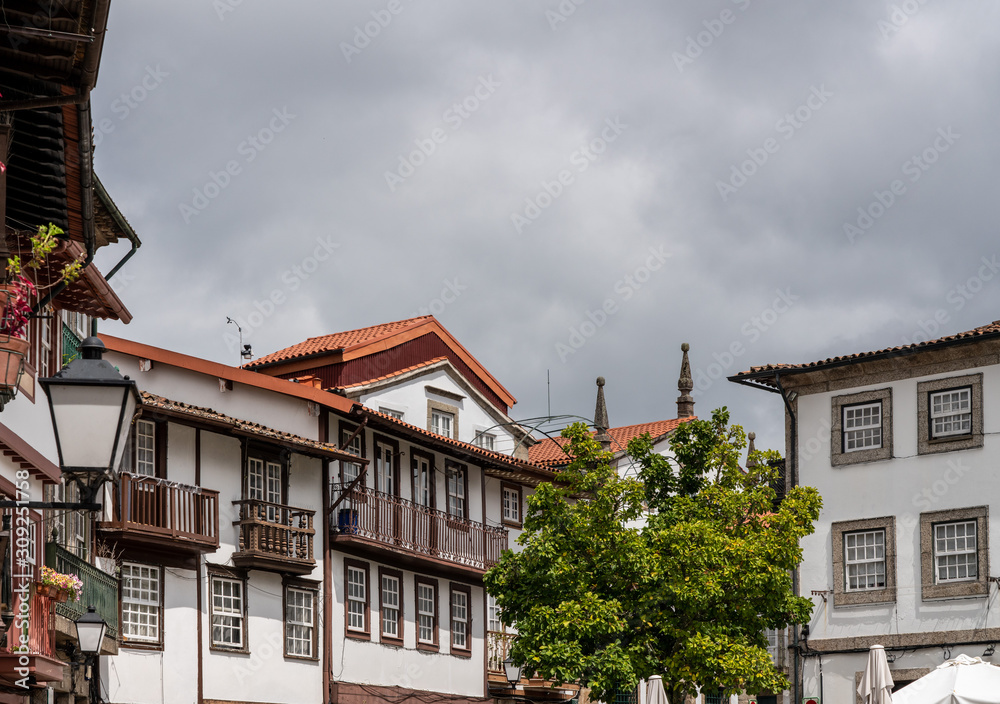 Carved balconies on traditional houses overlooking the main square in Guimaraes