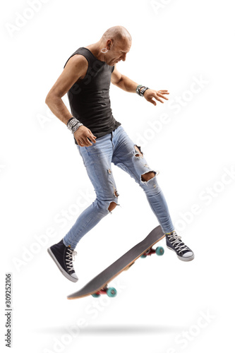 Bald guy jumping with a skateboard