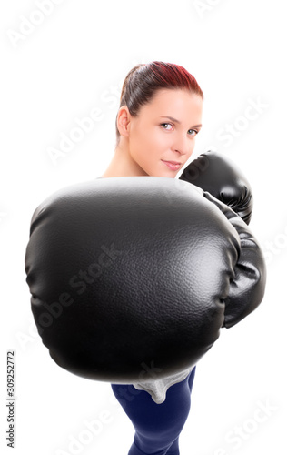 Young woman with boxing gloves punching the camera